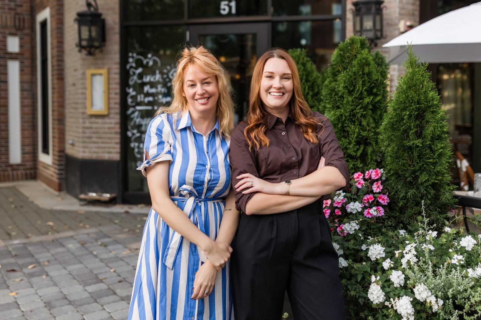 Zosia and Brittany smiling together outside a restaurant